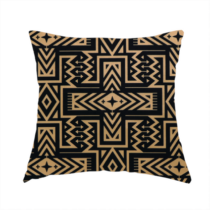 The fabric used to create this handmade cushion is a black and gold geometric fabric featuring an intricate Navajo-inspired tribal pattern with chevron lines, diamonds, and cross motifs.