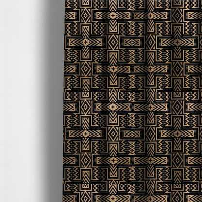 The fabric used to create these made-to-measure curtains is a black and gold geometric fabric featuring an intricate Navajo-inspired tribal pattern with chevron lines, diamonds, and cross motifs.