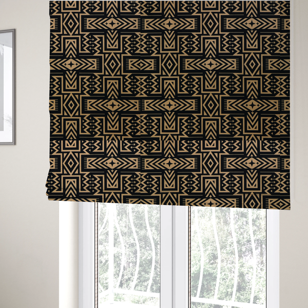 The fabric used to create these Roman blinds is a black and gold geometric fabric featuring an intricate Navajo-inspired tribal pattern with chevron lines, diamonds, and cross motifs.