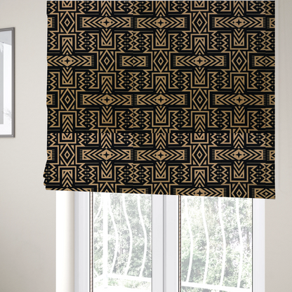 The fabric used to create these Roman blinds is a black and gold geometric fabric featuring an intricate Navajo-inspired tribal pattern with chevron lines, diamonds, and cross motifs.