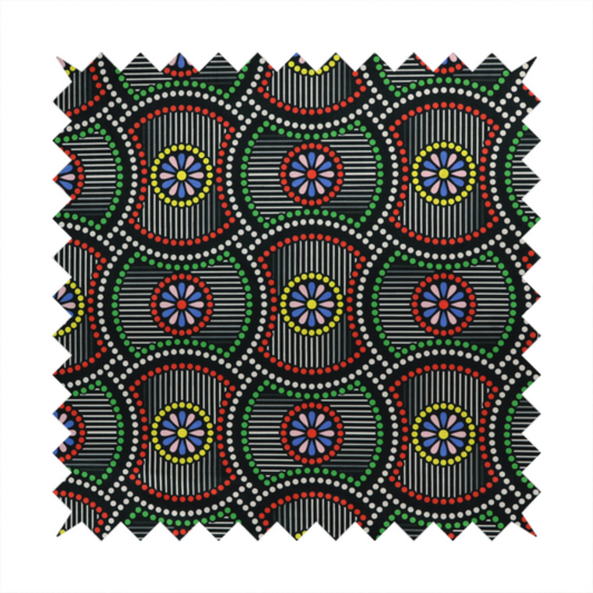 Vibrant multi-coloured fabric featuring a detailed dotted pattern with concentric circular motifs, floral-like centre rosettes, and striped geometric panels in black, red, green, blue, and yellow.   