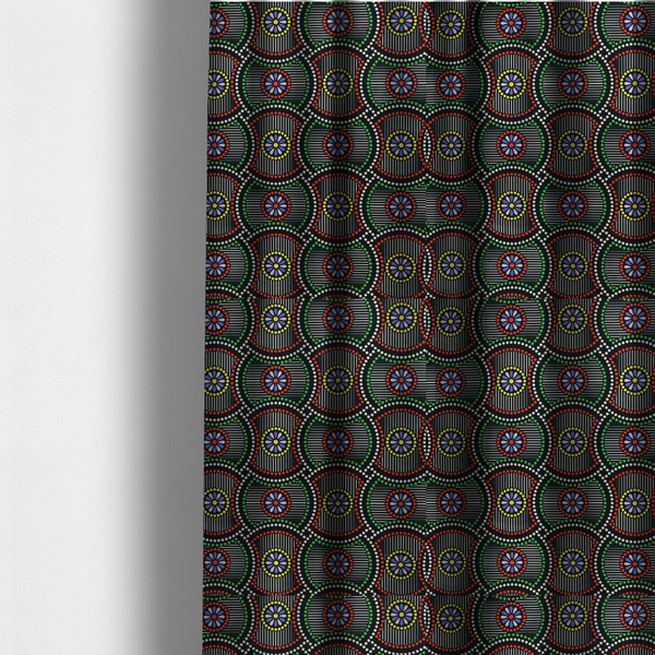 The fabric used to create these made-to-measure curtains is a vibrant multi-coloured fabric featuring a detailed dotted pattern with concentric circular motifs, floral-like centre rosettes, and striped geometric panels in black, red, green, blue, and yellow.   
