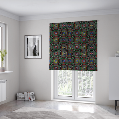 The fabric used to create these Roman blinds is a vibrant multi-coloured fabric featuring a detailed dotted pattern with concentric circular motifs, floral-like centre rosettes, and striped geometric panels in black, red, green, blue, and yellow.   
