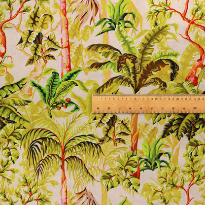 Lush tropical jungle fabric featuring a vibrant botanical pattern with palm trees, banana leaves, and exotic foliage in shades of green, yellow, and red.   
