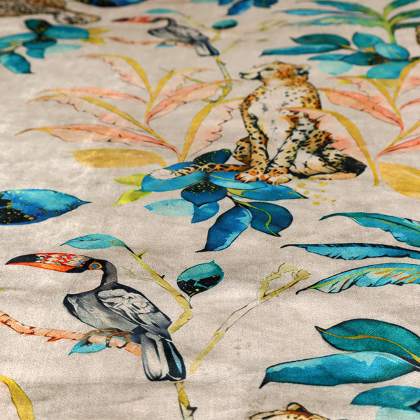Exotic cream, blue, and orange fabric featuring a tropical jungle pattern with leopards, cheetahs, toucans, exotic birds, and lush foliage.   