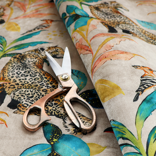 Exotic cream, blue, and orange fabric featuring a tropical jungle pattern with leopards, cheetahs, toucans, exotic birds, and lush foliage.   