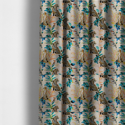The fabric used to create these made-to-measure curtains is an exotic cream, blue, and orange fabric featuring a tropical jungle pattern with leopards, cheetahs, toucans, exotic birds, and lush foliage.   