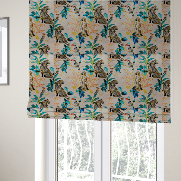 The fabric used to create these Roman blinds is an exotic cream, blue, and orange fabric featuring a tropical jungle pattern with leopards, cheetahs, toucans, exotic birds, and lush foliage.   