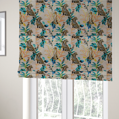 The fabric used to create these Roman blinds is an exotic cream, blue, and orange fabric featuring a tropical jungle pattern with leopards, cheetahs, toucans, exotic birds, and lush foliage.   