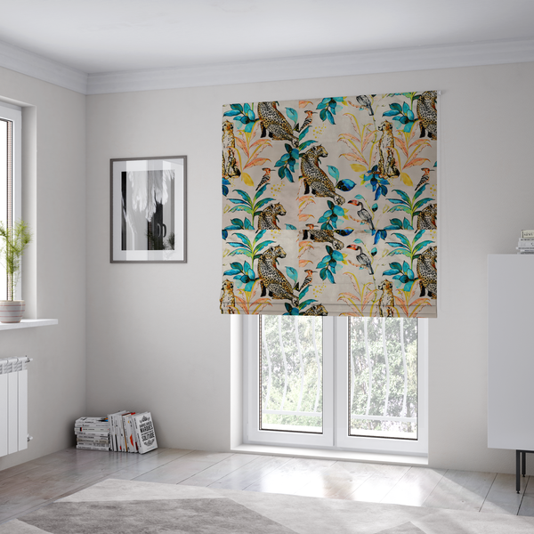 The fabric used to create these Roman blinds is an exotic cream, blue, and orange fabric featuring a tropical jungle pattern with leopards, cheetahs, toucans, exotic birds, and lush foliage.   