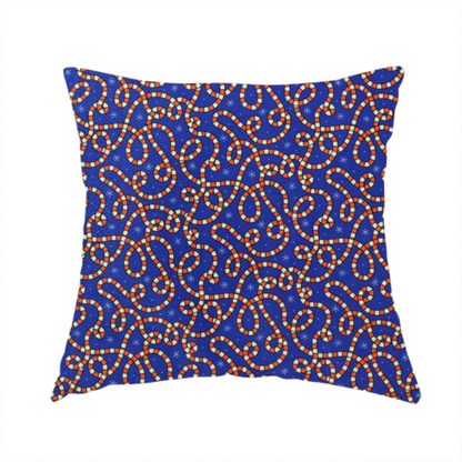 The fabric used to create this handmade cushion is a blue and red fabric featuring an intricate festive pattern with continuous wiggly candy cane lines and tiny white snowflakes scattered across the deep blue background.   