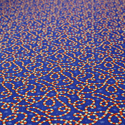 Blue and red fabric featuring an intricate festive pattern with continuous wiggly candy cane lines and tiny white snowflakes scattered across the deep blue background.   