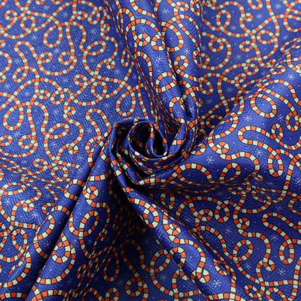 Blue and red fabric featuring an intricate festive pattern with continuous wiggly candy cane lines and tiny white snowflakes scattered across the deep blue background.   