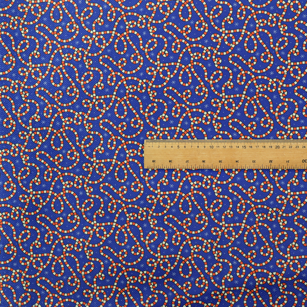Blue and red fabric featuring an intricate festive pattern with continuous wiggly candy cane lines and tiny white snowflakes scattered across the deep blue background.   