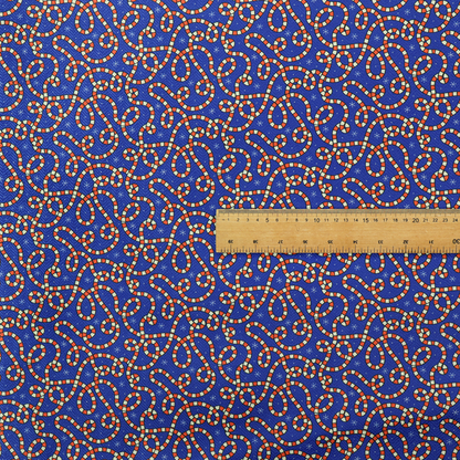 Blue and red fabric featuring an intricate festive pattern with continuous wiggly candy cane lines and tiny white snowflakes scattered across the deep blue background.   