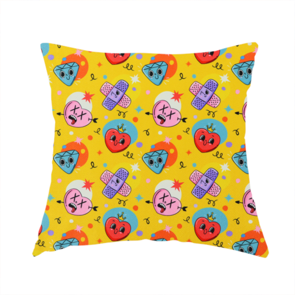 The fabric used to create this handmade cushion is a yellow fabric featuring a playful, quirky pattern with cartoon-style graphics including smiling hearts with crowns, cute diamonds, cartoon bandages, and wacky faces with X eyes on a bright yellow background.   