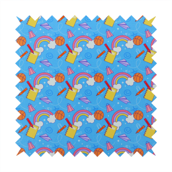 Blue fabric featuring a playful back-to-school pattern with colourful rainbows, basketballs, yellow notebooks with red pencils, purple paper airplanes, and school supplies scattered across a bright blue background.