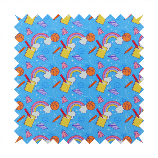 Blue fabric featuring a playful back-to-school pattern with colourful rainbows, basketballs, yellow notebooks with red pencils, purple paper airplanes, and school supplies scattered across a bright blue background.