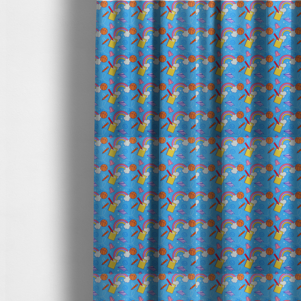 The fabric used to create these made-to-measure curtains is a blue fabric featuring a playful back-to-school pattern with colourful rainbows, basketballs, yellow notebooks with red pencils, purple paper airplanes, and school supplies scattered across a bright blue background.