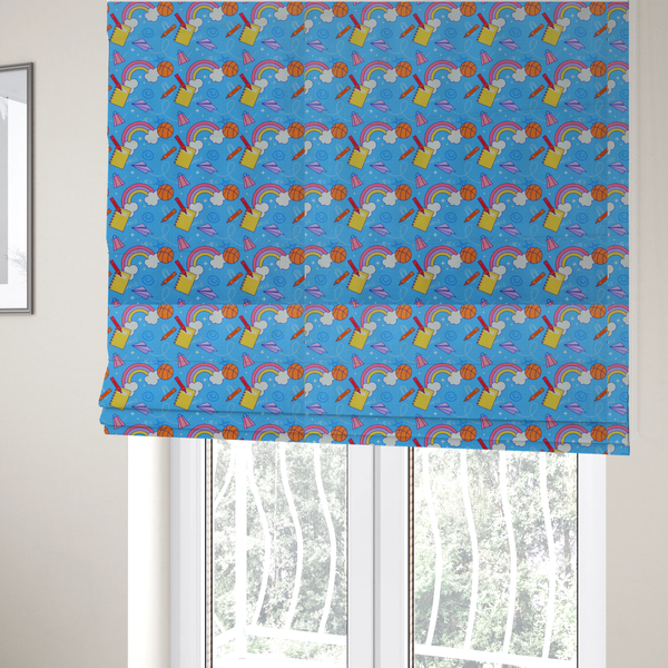 The fabric used to create these Roman blinds is a blue fabric featuring a playful back-to-school pattern with colourful rainbows, basketballs, yellow notebooks with red pencils, purple paper airplanes, and school supplies scattered across a bright blue background.