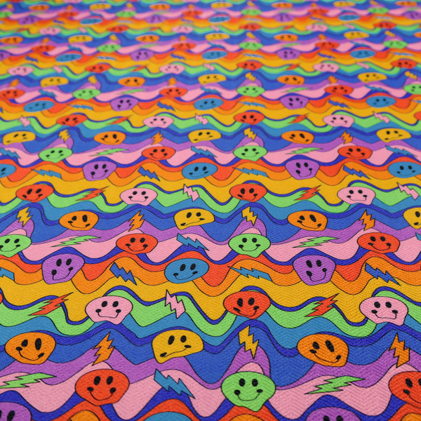 Multicolour fabric featuring a psychedelic groove pattern with wavy horizontal stripes in shades of blue, purple, green, yellow, and orange, interspersed with smiling smiley faces and lightning bolts.