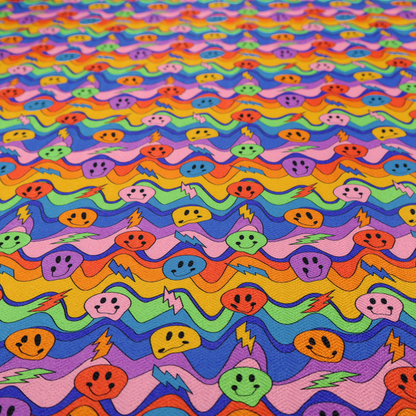 Multicolour fabric featuring a psychedelic groove pattern with wavy horizontal stripes in shades of blue, purple, green, yellow, and orange, interspersed with smiling smiley faces and lightning bolts.