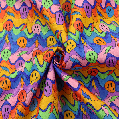 Multicolour fabric featuring a psychedelic groove pattern with wavy horizontal stripes in shades of blue, purple, green, yellow, and orange, interspersed with smiling smiley faces and lightning bolts.