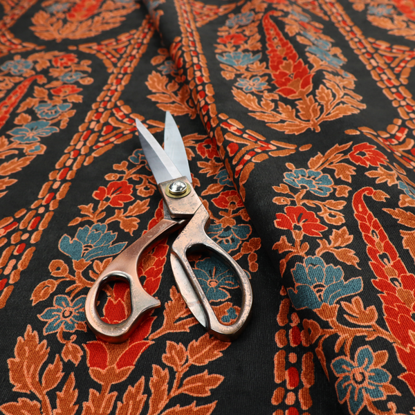 Ornate botanical paisley pattern with large vertical oval medallions filled with red floral motifs, orange leaves, and blue flowers, separated by decorative dashed stripes.