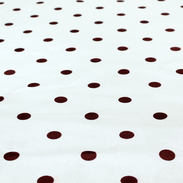 White and brown fabric featuring a classic polka dot pattern with evenly spaced dark dots set against a clean white background.   
PNG