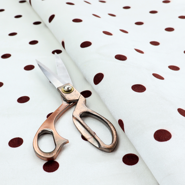 White and brown fabric featuring a classic polka dot pattern with evenly spaced dark dots set against a clean white background.   
PNG