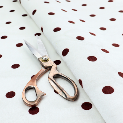 White and brown fabric featuring a classic polka dot pattern with evenly spaced dark dots set against a clean white background.   
PNG