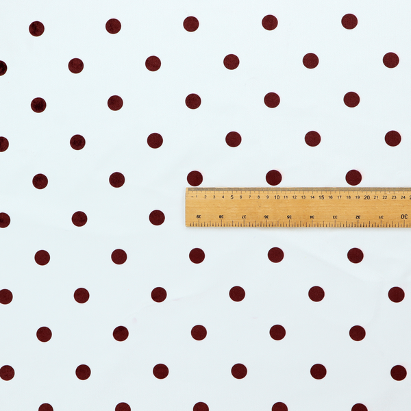 White and brown fabric featuring a classic polka dot pattern with evenly spaced dark dots set against a clean white background.   
PNG