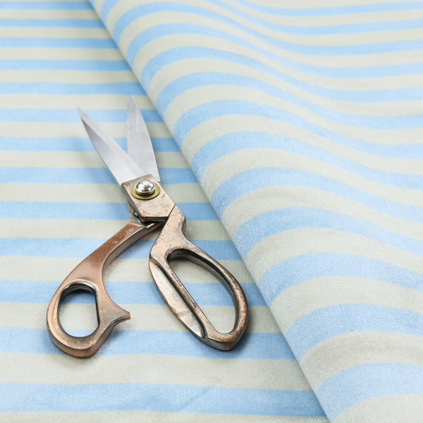 Horizontal light blue and white striped fabric pattern.