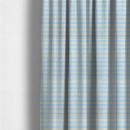 The fabric used to create these made-to-measure curtains is a horizontal light blue and white striped fabric pattern.
