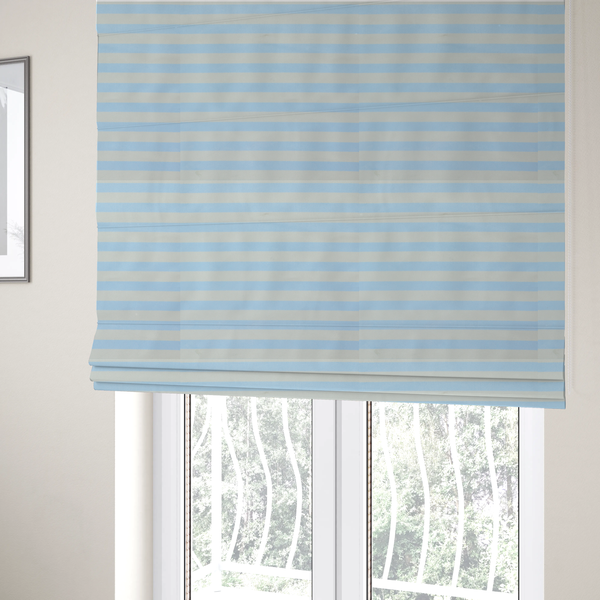 The fabric used to create these Roman blinds is a horizontal light blue and white striped fabric pattern.