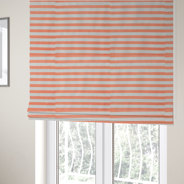 The fabric used to create these Roman blinds is a horizontal coral and white striped fabric pattern.