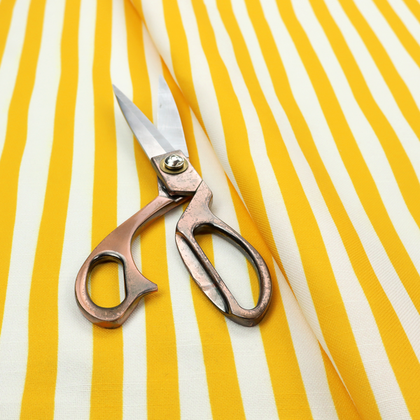 A white fabric patterned with vertical, hand-drawn yellow stripes that feature a slight, organic waviness.   

