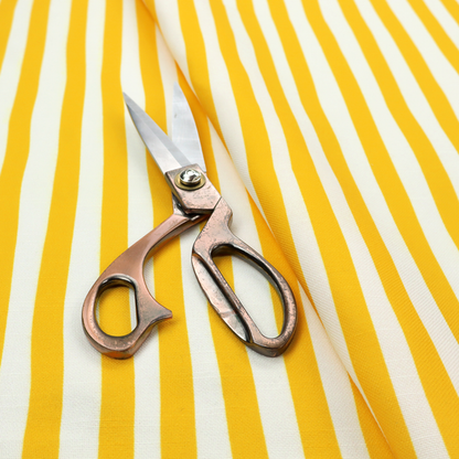 A white fabric patterned with vertical, hand-drawn yellow stripes that feature a slight, organic waviness.   
