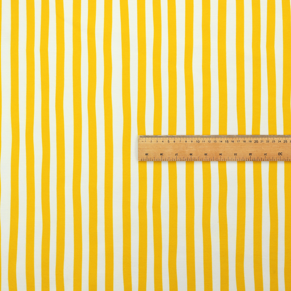 A white fabric patterned with vertical, hand-drawn yellow stripes that feature a slight, organic waviness.   
