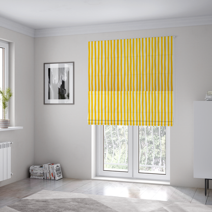 The fabric used to create these Roman blinds is a white fabric patterned with vertical, hand-drawn yellow stripes that feature a slight, organic waviness.   

