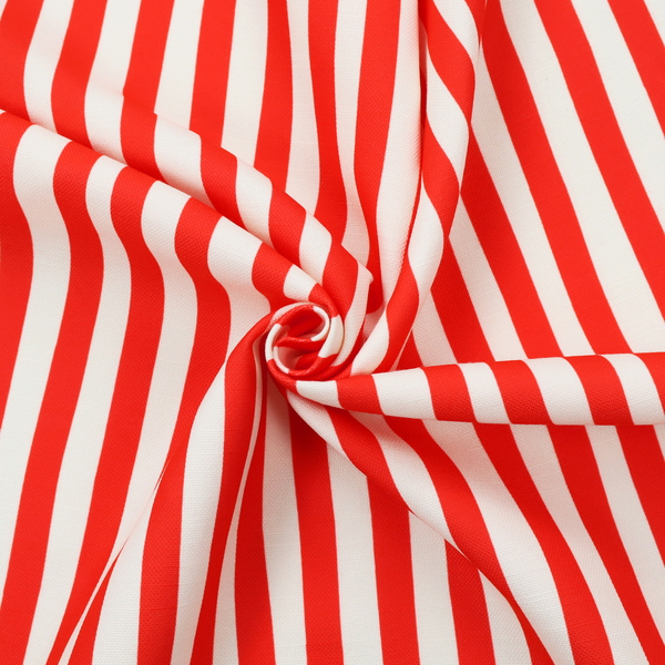A white fabric patterned with vertical, hand-drawn red stripes that feature a slight, organic waviness.