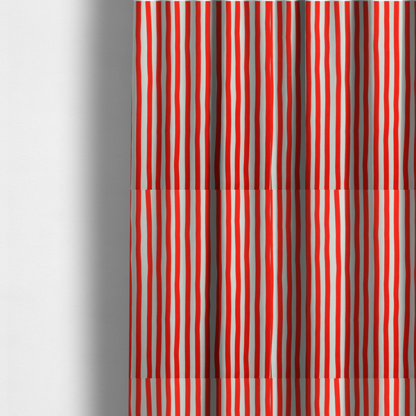The fabric used to create these made-to-measure curtains is a white fabric patterned with vertical, hand-drawn red stripes that feature a slight, organic waviness.