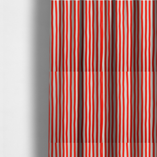 The fabric used to create these made-to-measure curtains is a white fabric patterned with vertical, hand-drawn red stripes that feature a slight, organic waviness.