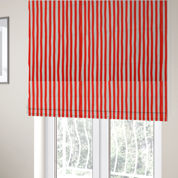 The fabric used to create these Roman blinds is a white fabric patterned with vertical, hand-drawn red stripes that feature a slight, organic waviness.