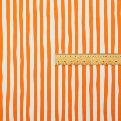 A white fabric patterned with vertical, hand-drawn orange stripes that feature a slight, organic waviness.