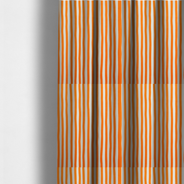 The fabric used to create these made-to-measure curtains is a white fabric patterned with vertical, hand-drawn orange stripes that feature a slight, organic waviness.