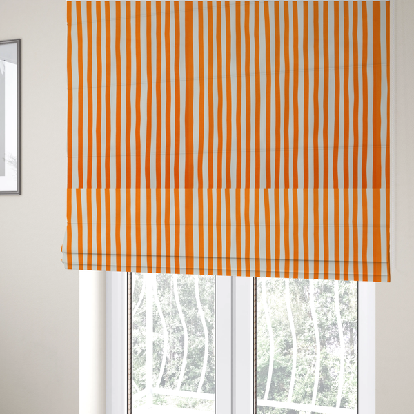 The fabric used to create these Roman blinds is a white fabric patterned with vertical, hand-drawn orange stripes that feature a slight, organic waviness.