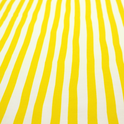 A white fabric patterned with vertical, hand-drawn yellow stripes that feature a slight, organic waviness.