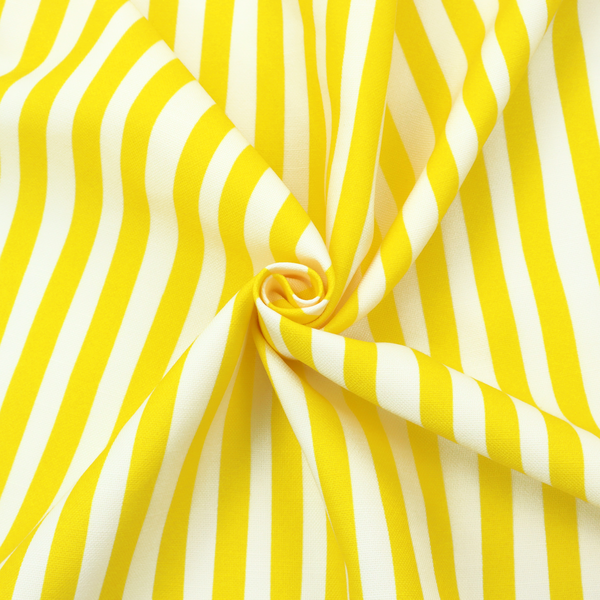 A white fabric patterned with vertical, hand-drawn yellow stripes that feature a slight, organic waviness.