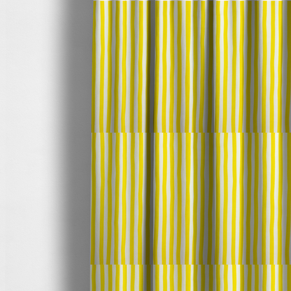 The fabric used to create these made-to-measure curtains is a white fabric patterned with vertical, hand-drawn yellow stripes that feature a slight, organic waviness.